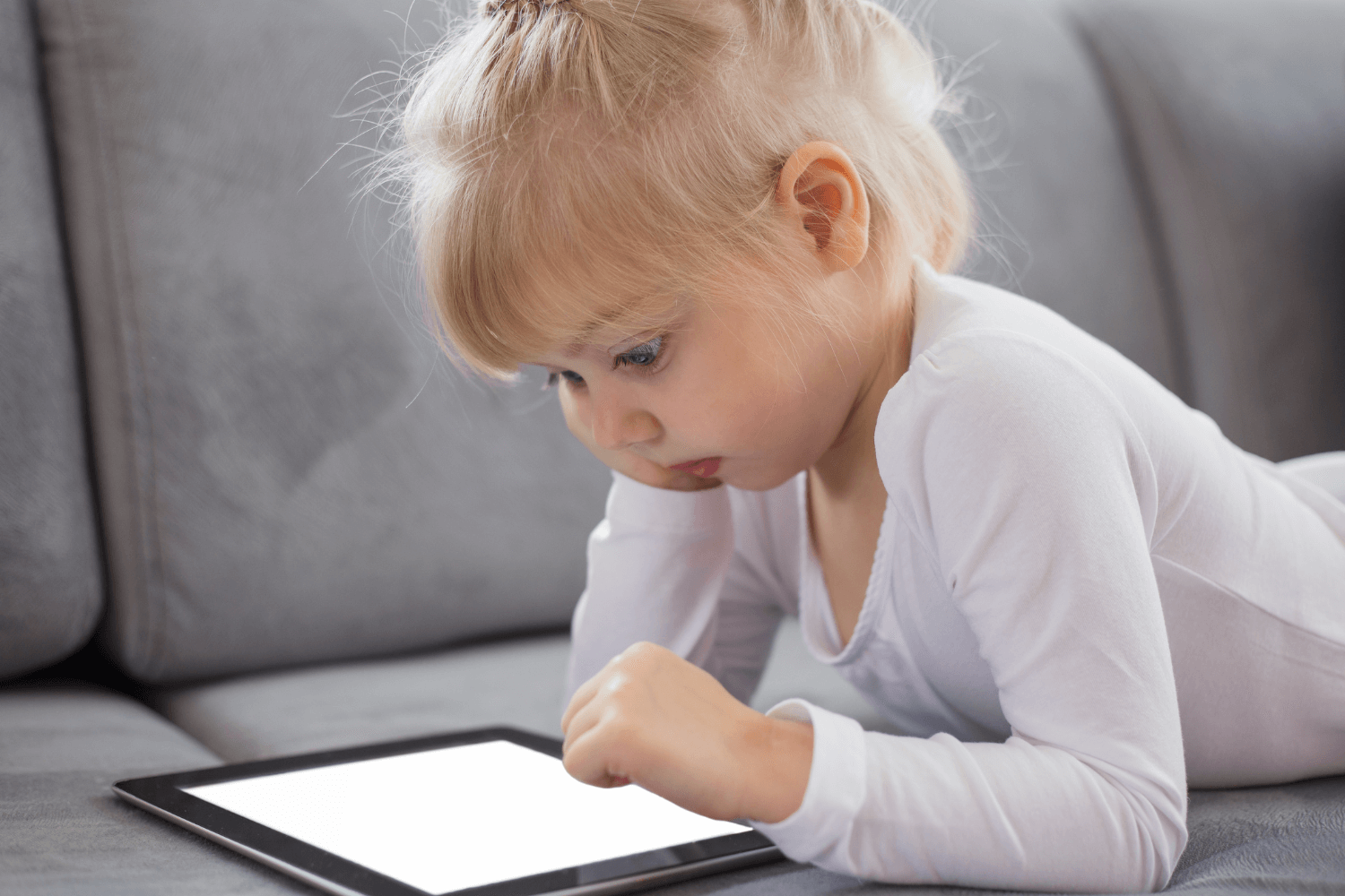 Child using iPad and parents playing Roblox together, representing balanced screen time