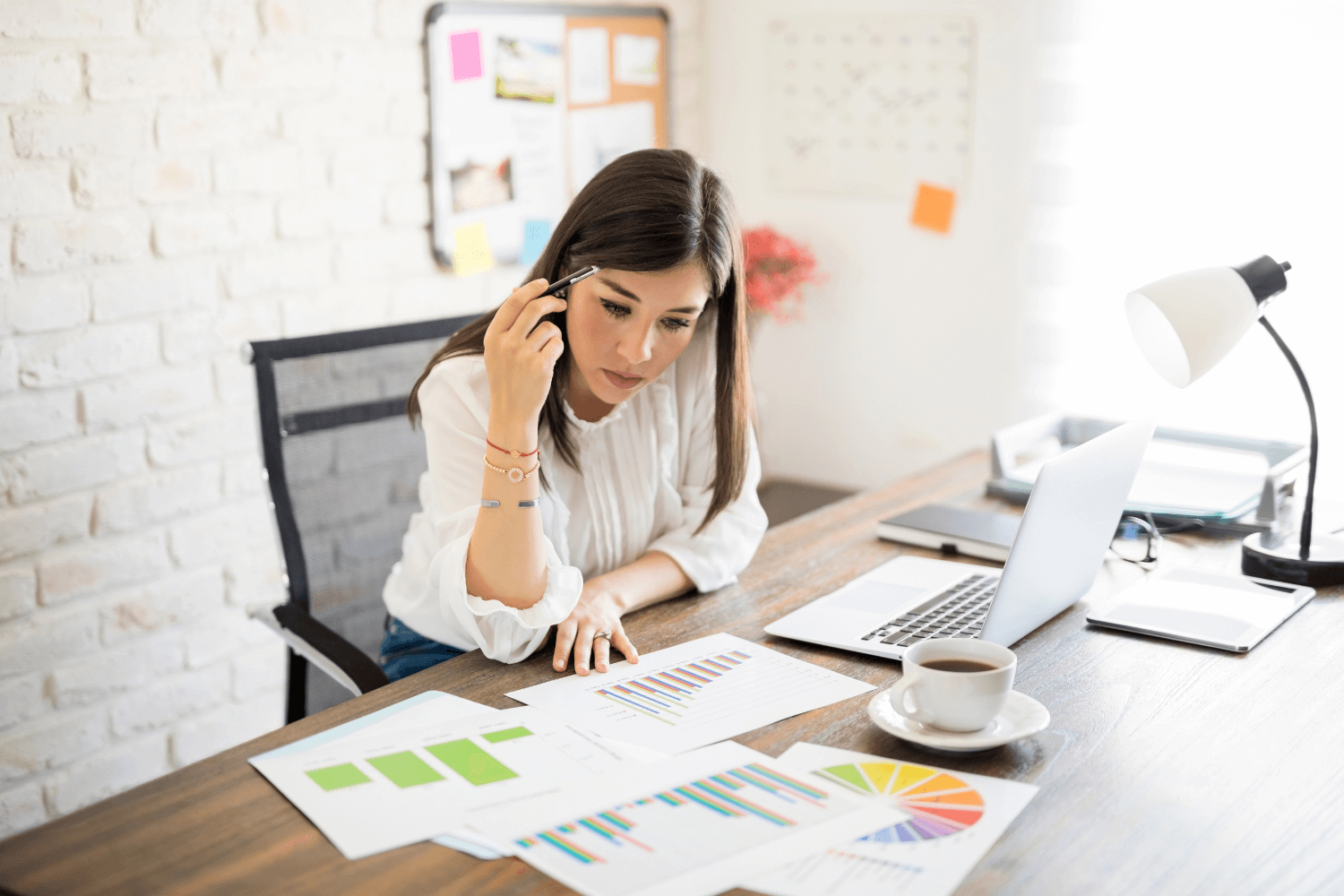 Businesswoman analysing Facebook ad reports with a concerned expression.