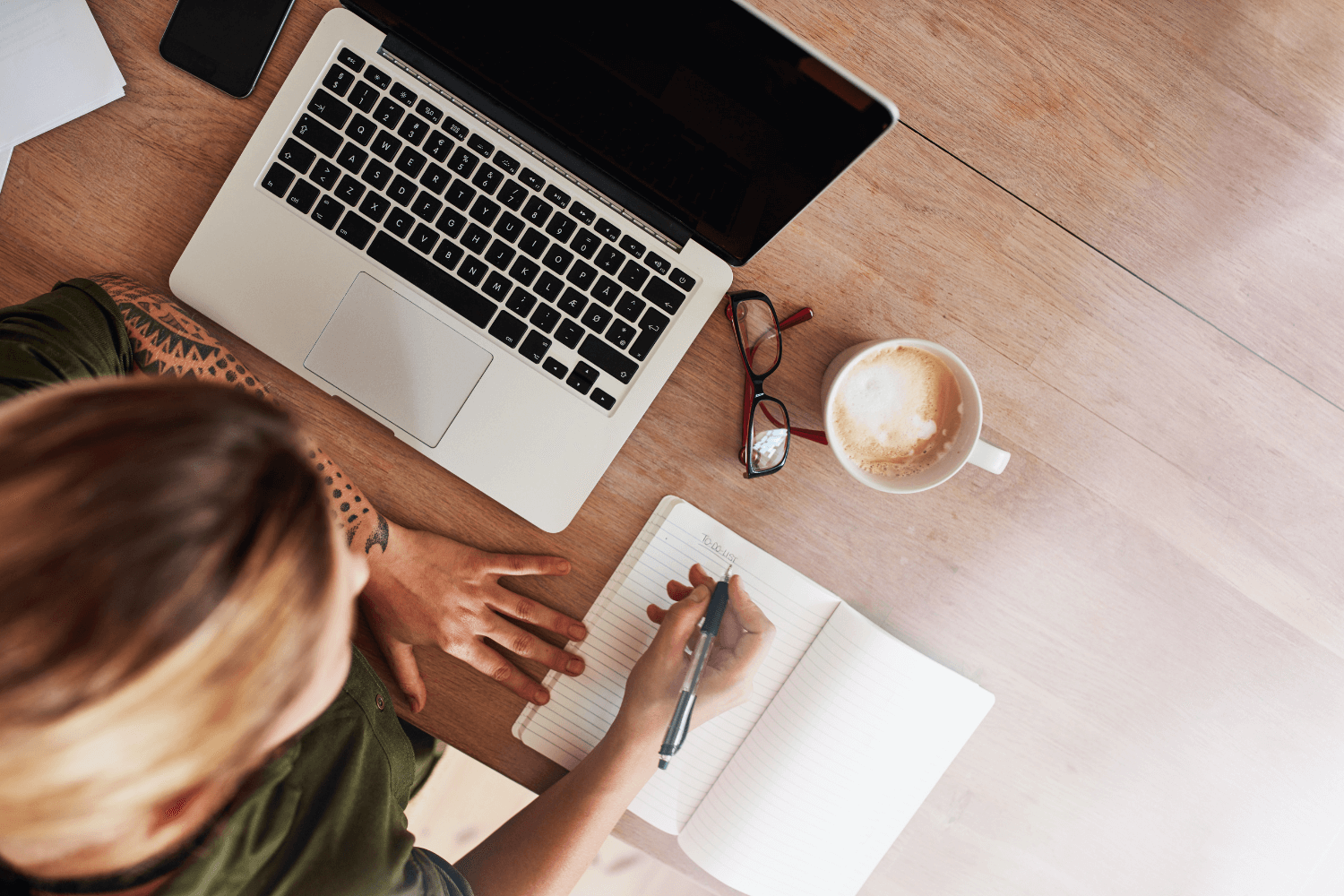 Laptop and notepad showing email marketing strategy for service-based business