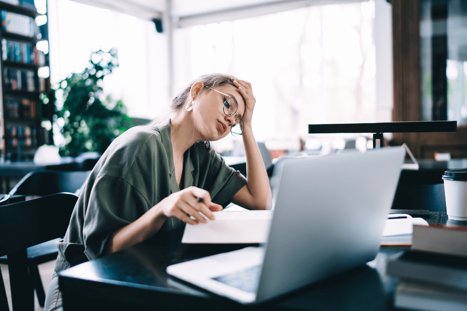 Overwhelmed woman managing marketing on laptop with multiple tabs open