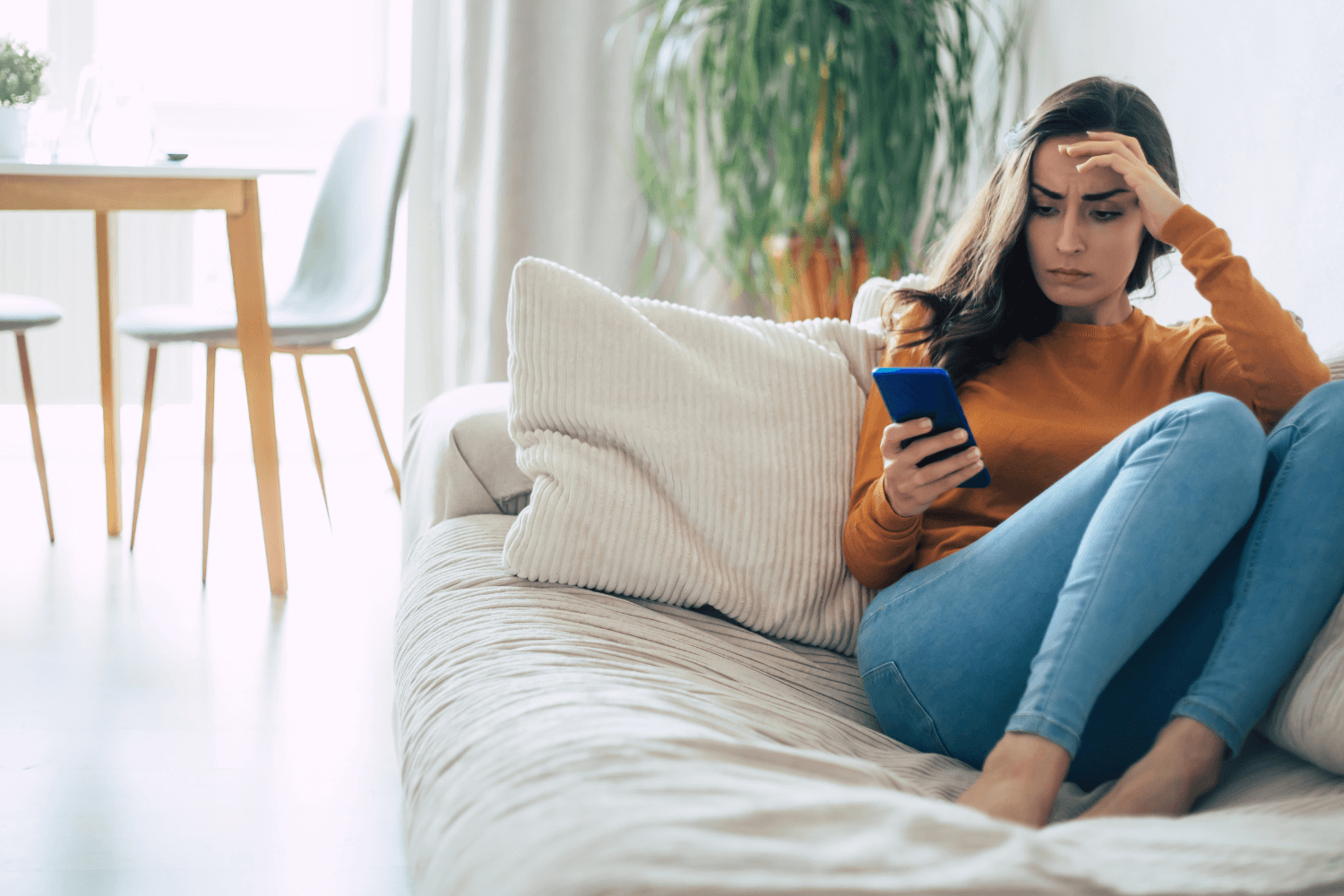 Frustrated business owner reviewing social media performance on smartphone