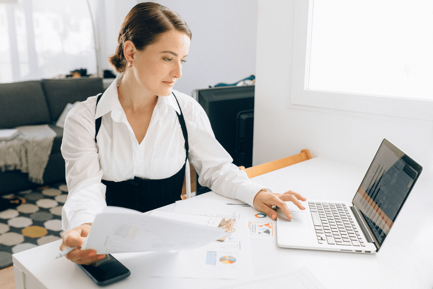 Small business owner conducting a marketing audit on her laptop