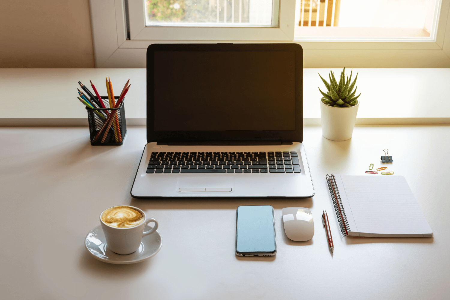 A business owner planning their marketing strategy with coffee and notebook